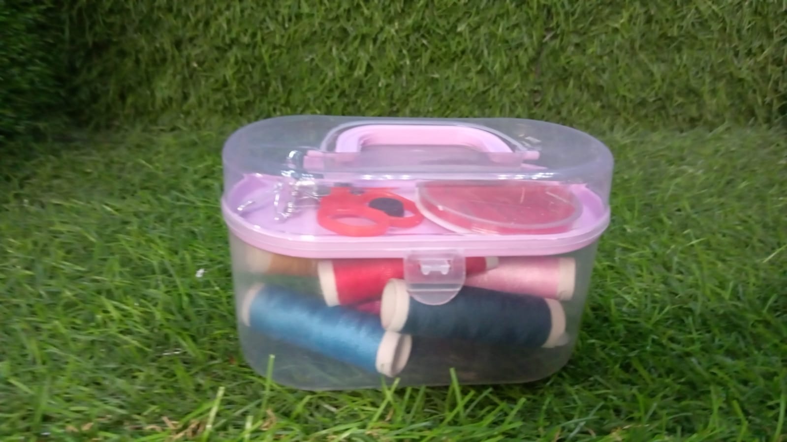 Portable sewing box with essential tools like needles, threads, and scissors.